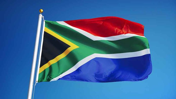 South African flag waving against blue sky.