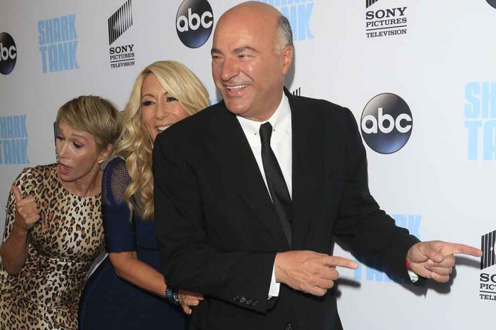 members of the Shark Tank cast in front of a wall at an ABC media event