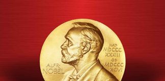 Gold Nobel Prize medal on red background.