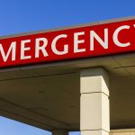 Red "EMERGENCY" sign on building facade.