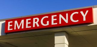 Red "EMERGENCY" sign on building facade.