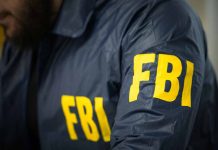 Person wearing FBI jacket with yellow lettering