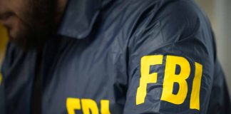 Person wearing FBI jacket with yellow lettering