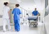 Doctors and nurses in hospital corridor with stretcher