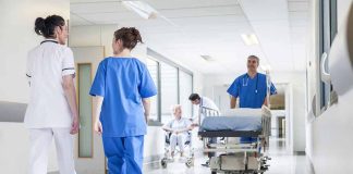 Doctors and nurses in hospital corridor with stretcher