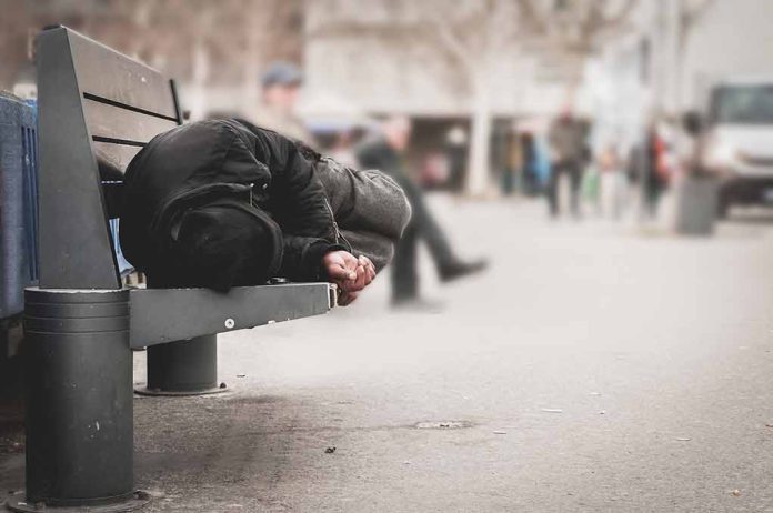 Person sleeping on a bench in a public area.