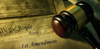 Gavel, Constitution, and document showing "1st Amendment."