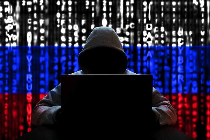 Hacker silhouette with Russian flag and code background