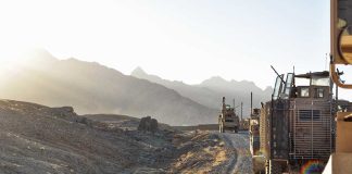 Military vehicles on a mountainous dirt road