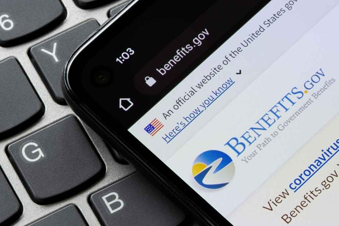 close up of a smartphone screen with the website for Benefits dot gov on it.