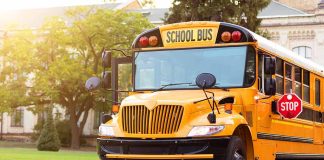 Yellow school bus with extended stop sign.