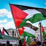 Protest with Palestinian flags waving in the air