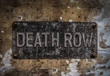 Weathered Death Row sign on aged concrete wall