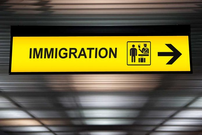 Yellow immigration sign with arrow pointing right.