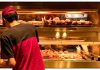 Person in red shirt at fried chicken counter