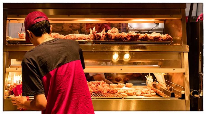 Person in red shirt at fried chicken counter