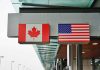 Canadian and American flags hanging at a border crossing