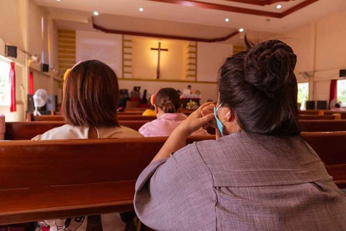 People sitting in church pews during service.