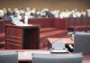 Empty courtroom with microphones and a podium