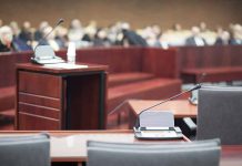 Empty courtroom with microphones and a podium