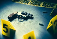 Revolver on table with crime scene markers