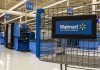 Walmart shopping cart inside store near checkout aisle