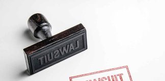 Rubber stamp labeled lawsuit on white background