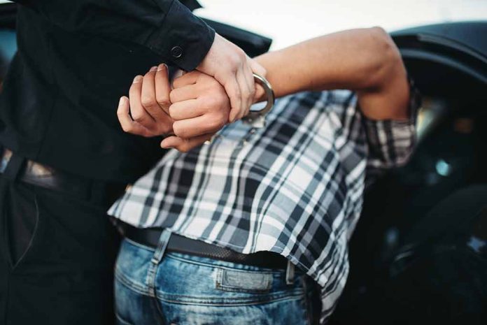 1144500824 featured image Person in handcuffs being arrested by police.