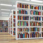 Modern library with rows of colorful bookshelves.