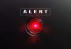 Red alert button on black background