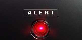 Red alert button on black background
