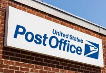 United States Post Office sign on brick building