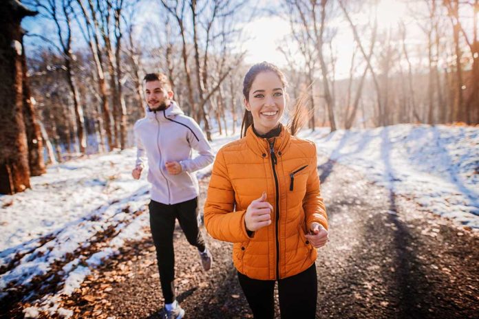 1196192464 featured image Two people jogging on a snowy path outdoors