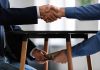 Handshake and exchange of money under the table
