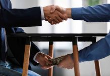 Handshake and exchange of money under the table