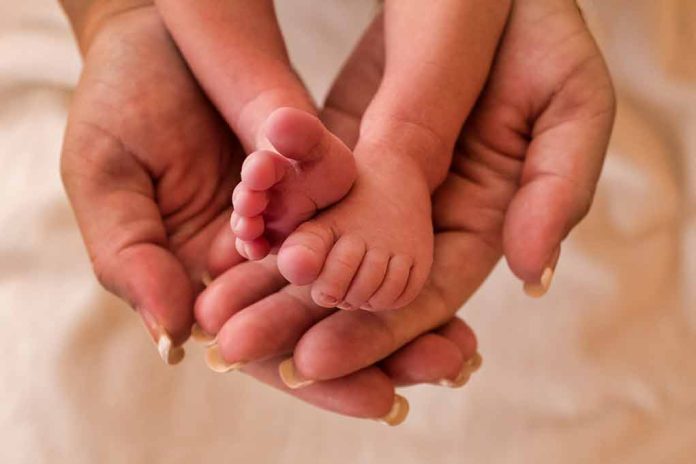 1247118406 featured image Adult hands holding a babys tiny feet