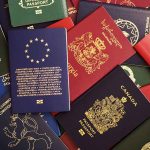 Various colorful international passports spread out