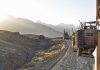 Military vehicles on a mountainous dirt road