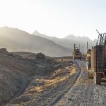 Military vehicles on a mountainous dirt road