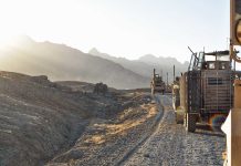 Military vehicles on a mountainous dirt road