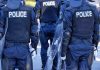Police officers in riot gear with shields