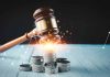 Gavel, coins, and tax icons on a table