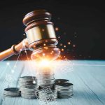 Gavel, coins, and tax icons on a table