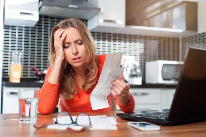 254511226 featured image Woman looking stressed holding bills in kitchen