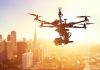 Drone flying over city at sunset time