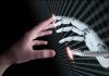 Human and robotic hand reaching out to touch