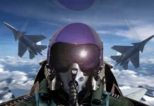 Pilot in cockpit with two fighter jets outside