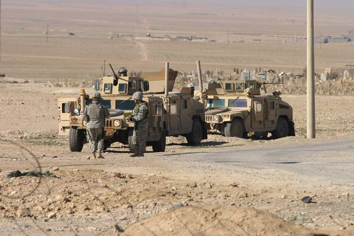 76580419 featured image Soldiers standing near armored vehicles in desert terrain