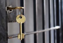 Key in lock of prison cell door.