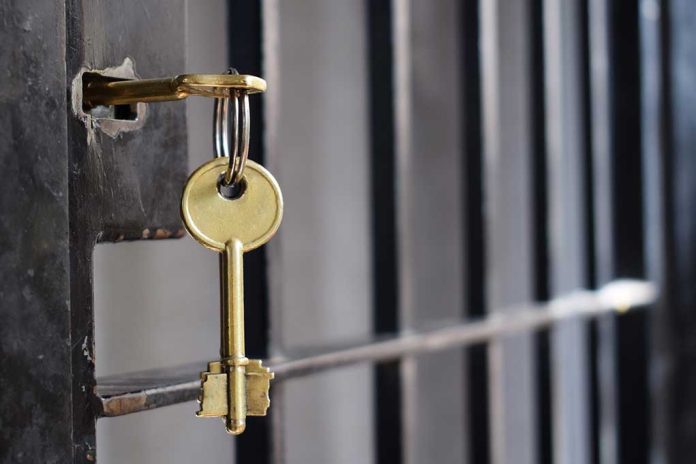 1134195950 featured image Key in lock of prison cell door.